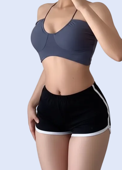 Person taking a mirror selfie wearing a sports bra and shorts on a plain background
