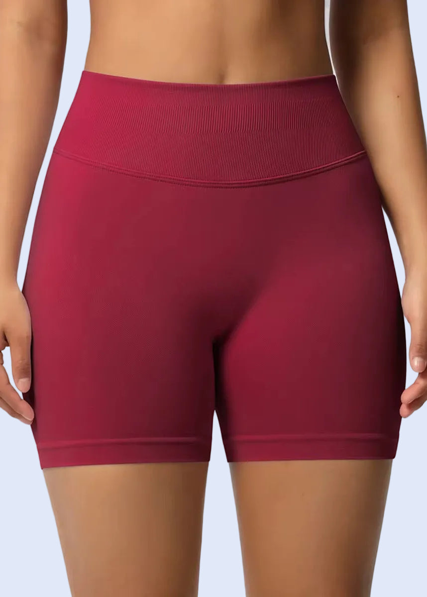Maroon athletic shorts worn by a person on a plain background