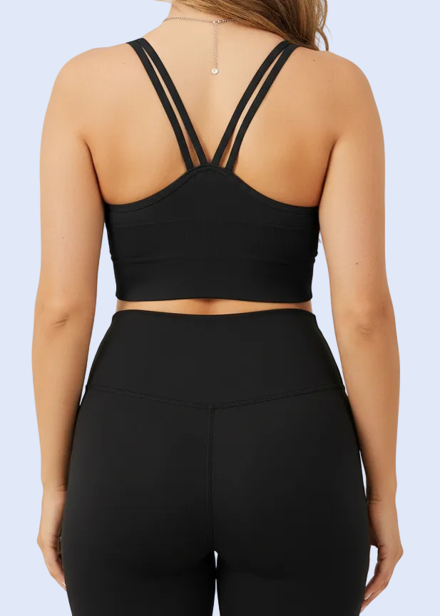 Black sports bra worn by a person with a neutral background