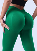 Person wearing green leggings on a white background