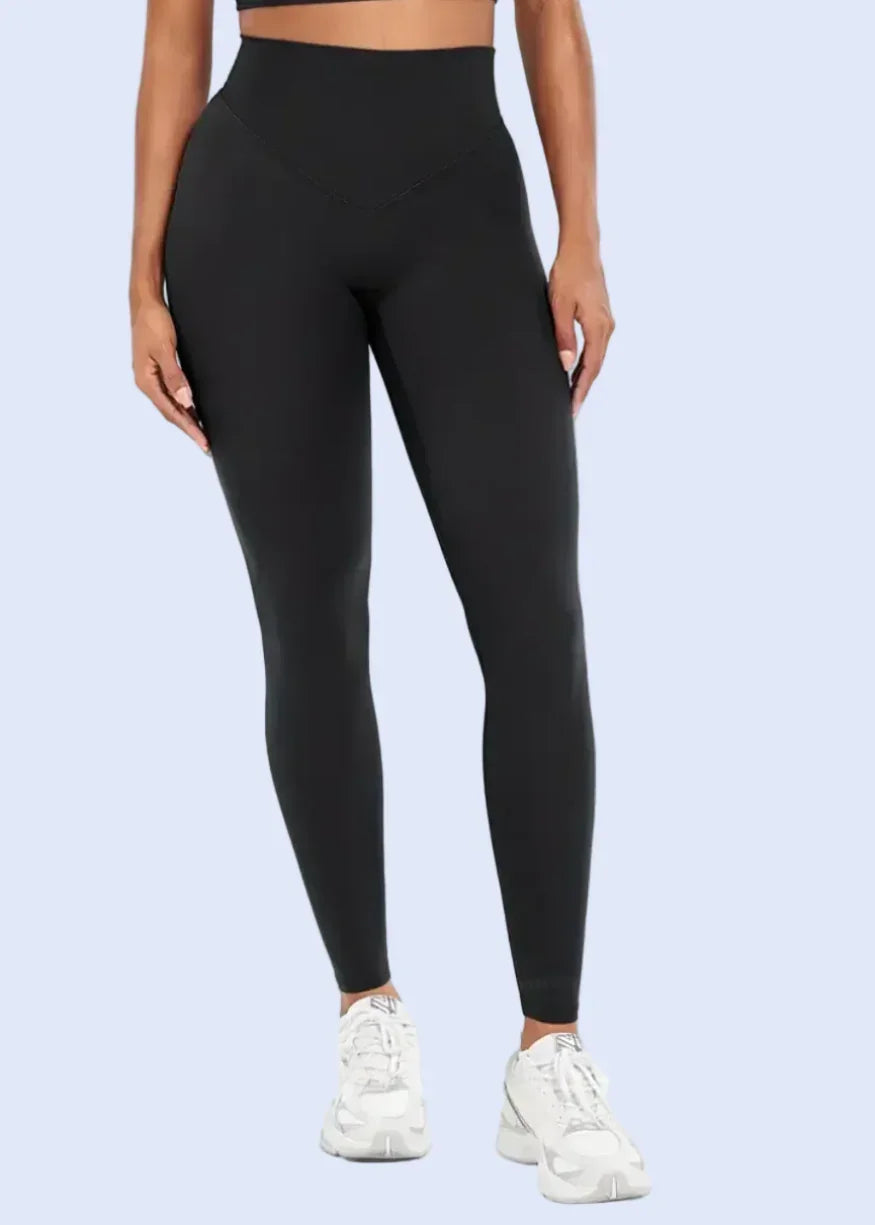 Person wearing black leggings on a white background