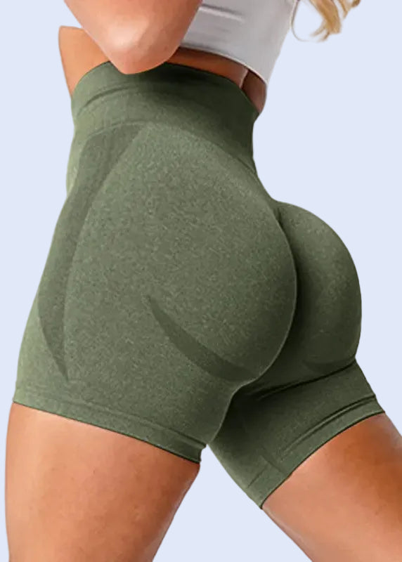 Green athletic shorts worn by a person on a white background