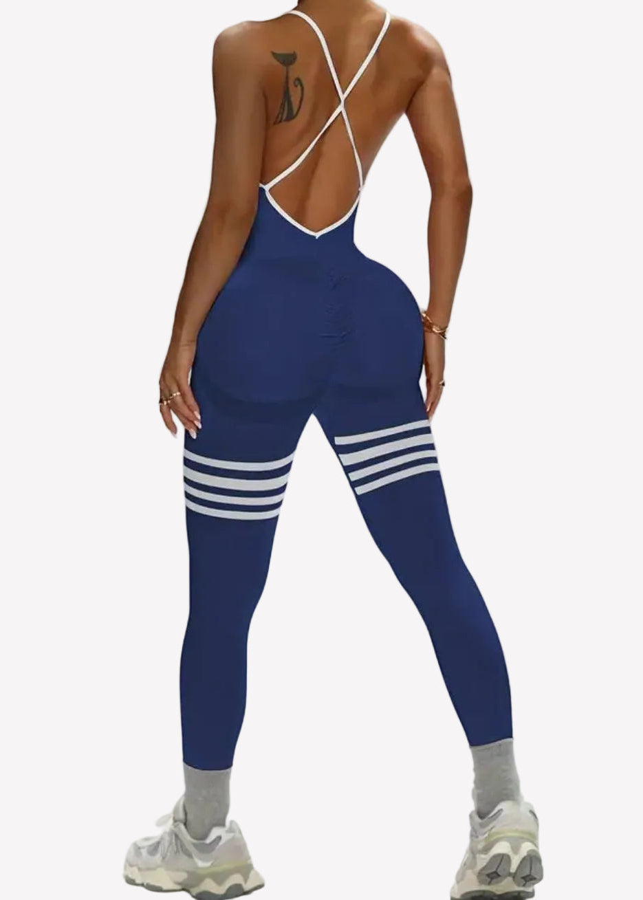 Woman wearing a blue athletic outfit with white stripes on a white background