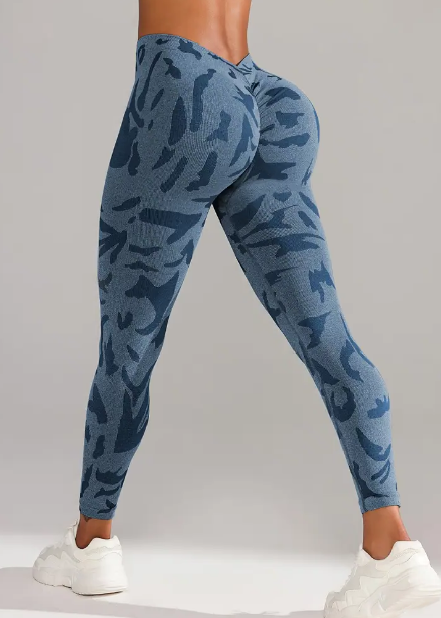 Blue patterned leggings worn by a person on a gray background