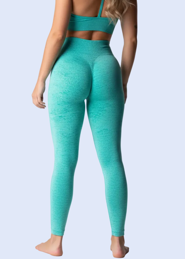 Turquoise athletic outfit worn by a model on a white background with product details.