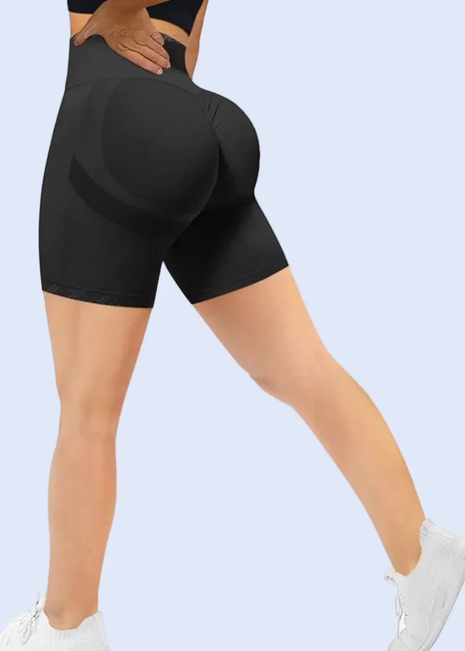 Black gym leggings worn by a person on a white background