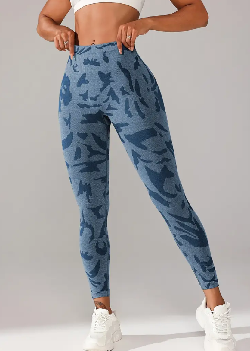 Person wearing blue camouflage pants on a gray background