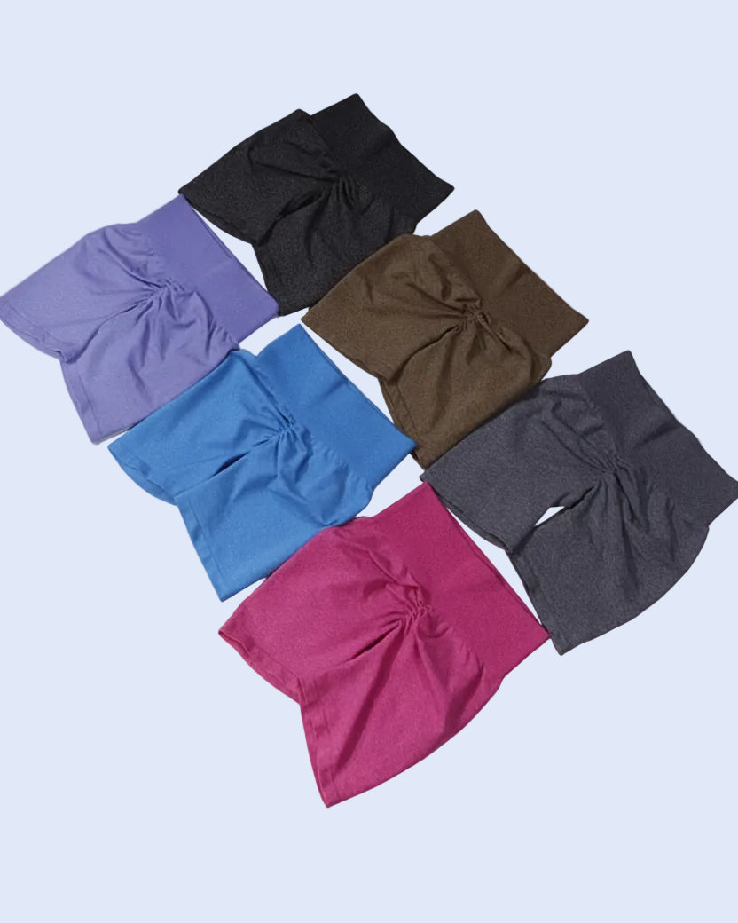 Set of colorful shorts in various colors on a light gray background