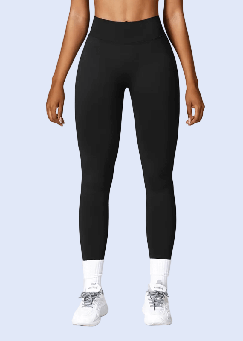 Person wearing a black athletic outfit on a white background