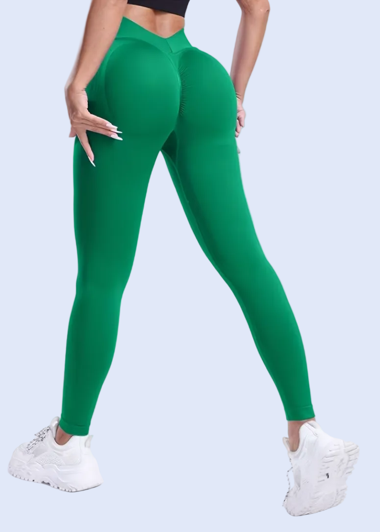 Person wearing green leggings on a white background