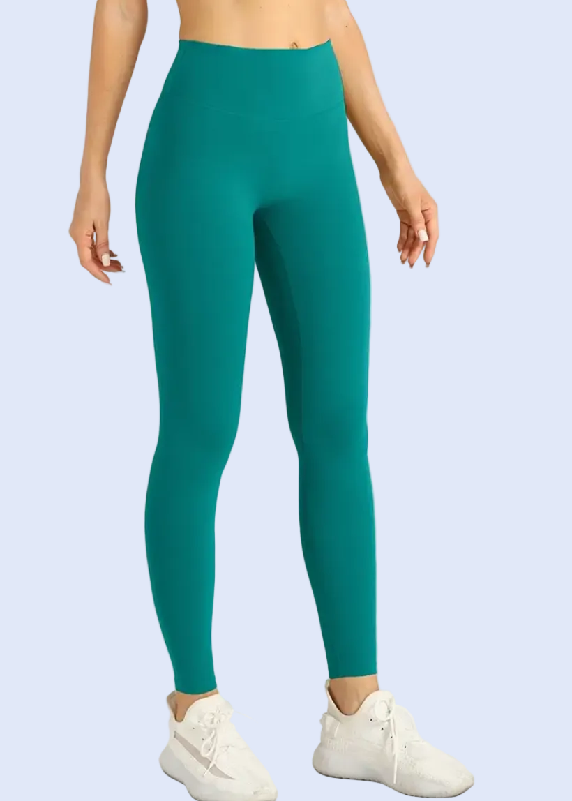Person wearing teal leggings on a white background