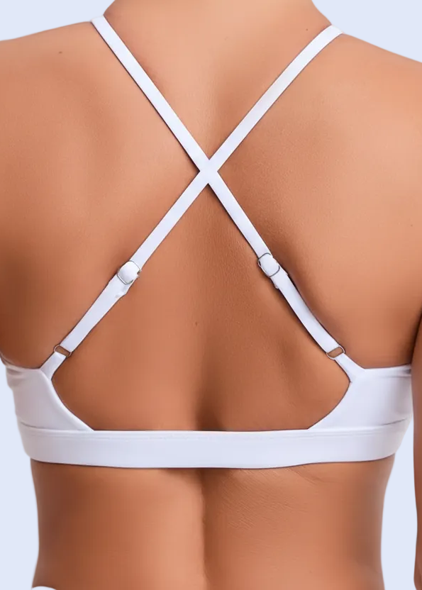 White strappy top worn by a person on a plain background