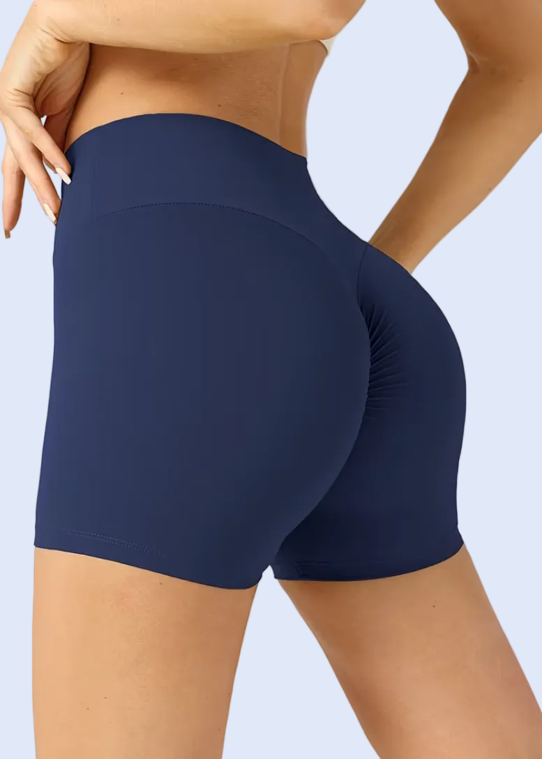 Navy blue athletic shorts worn by a person on a white background