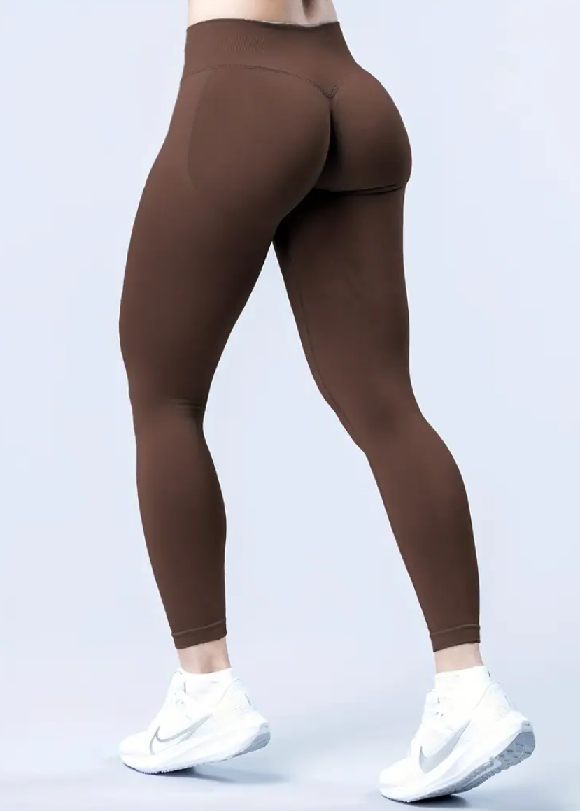 Brown leggings worn by a person on a light gray background