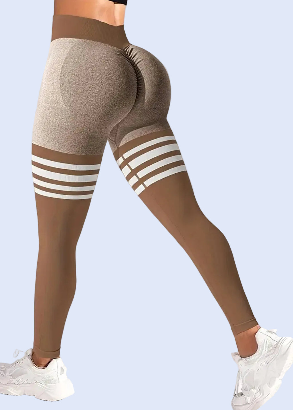 Brown leggings with white stripes worn by a person on a plain background