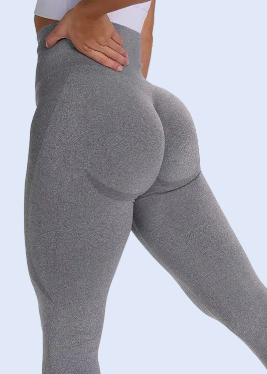 Person wearing gray leggings on a white background