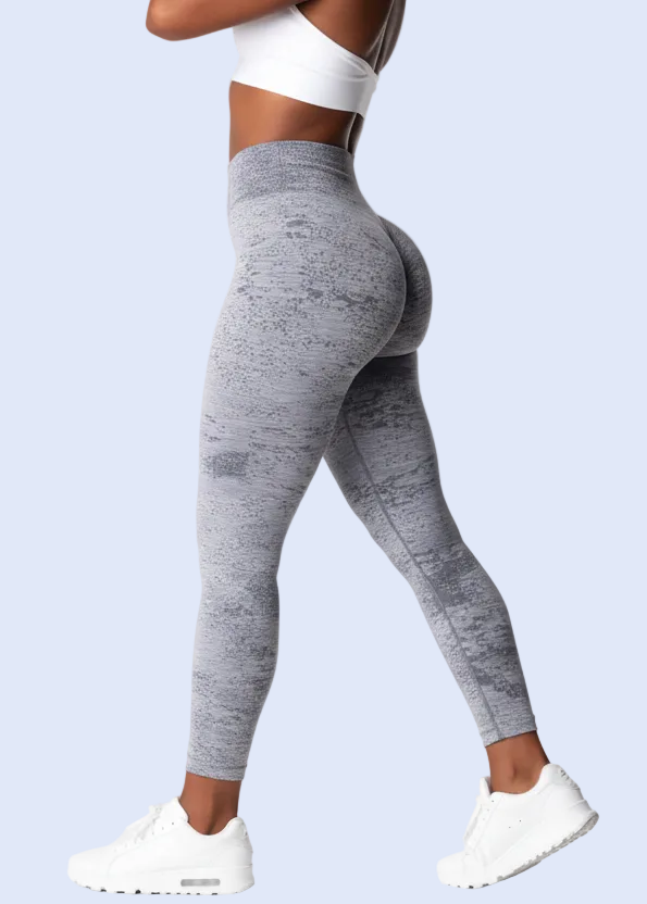 Person wearing gray leggings and a white sports bra on a white background with product details at the bottom.