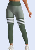 Green leggings with white stripes worn by a person on a light gray background