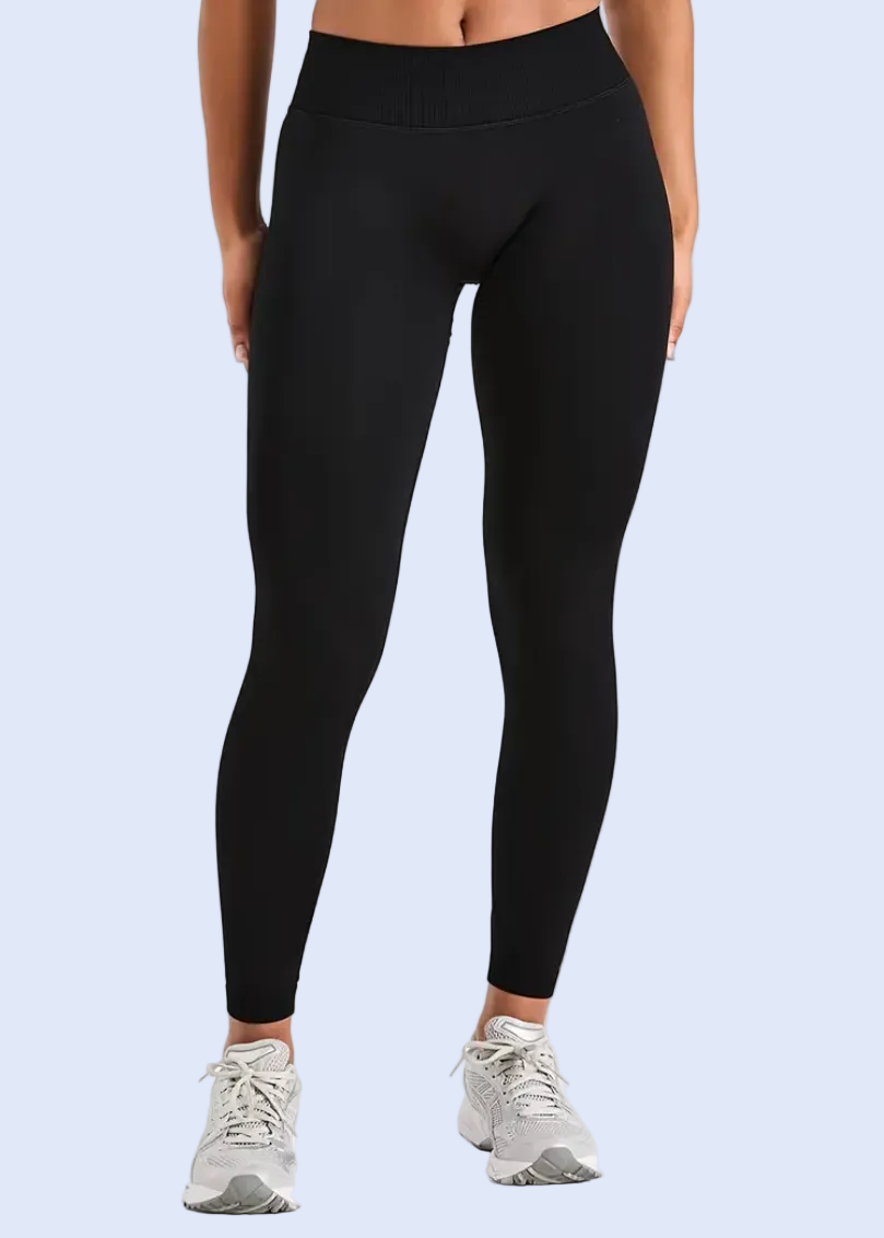 Person wearing black leggings on a white background