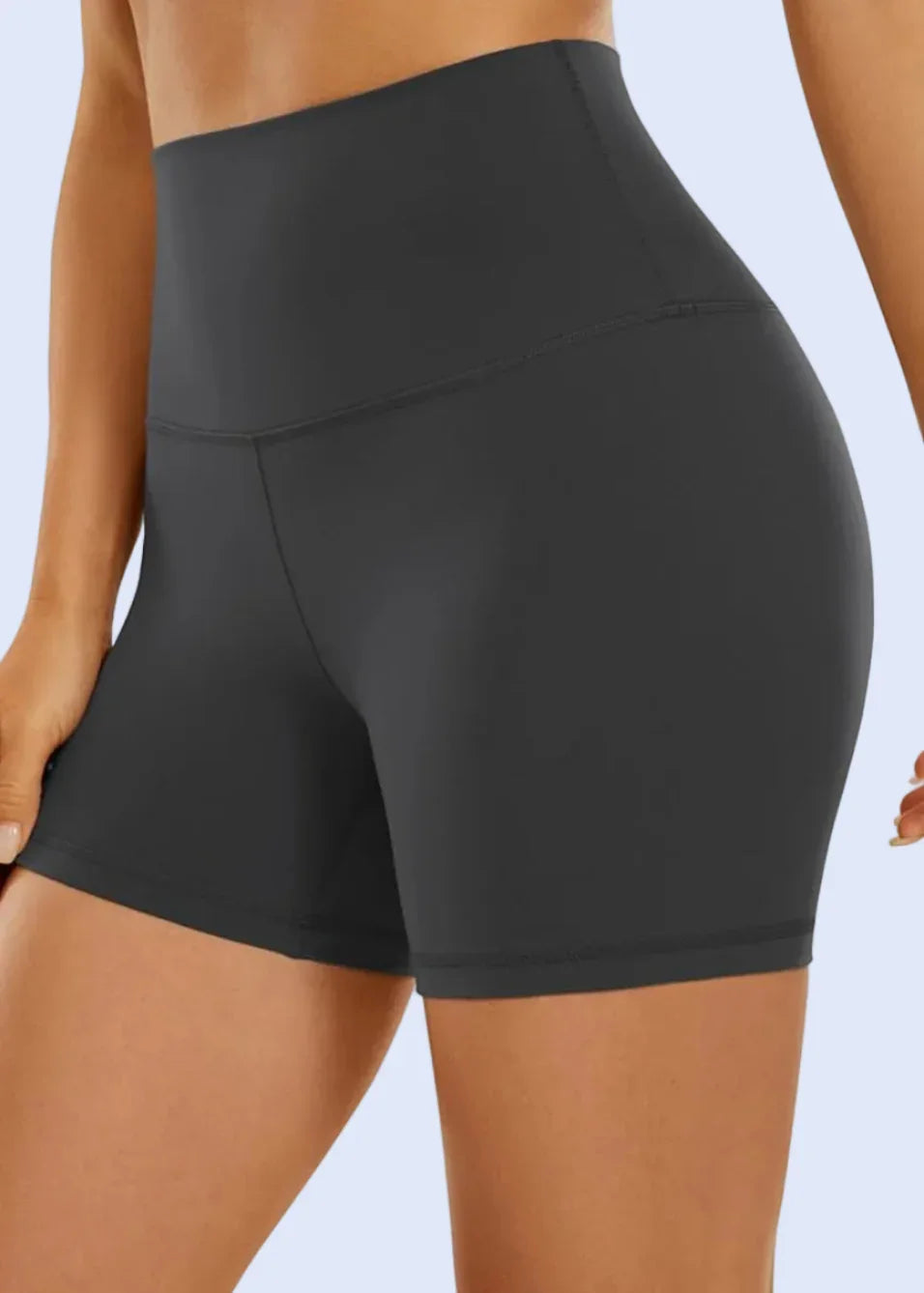 Black athletic shorts being worn on a white background with Amazon.com displayed in the browser tab.