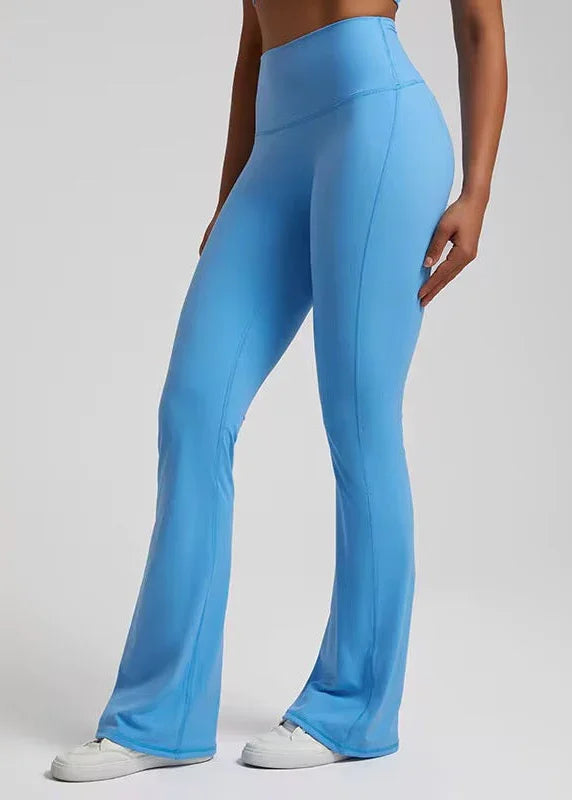 Woman wearing high-waisted blue flared activewear leggings from GymDeity