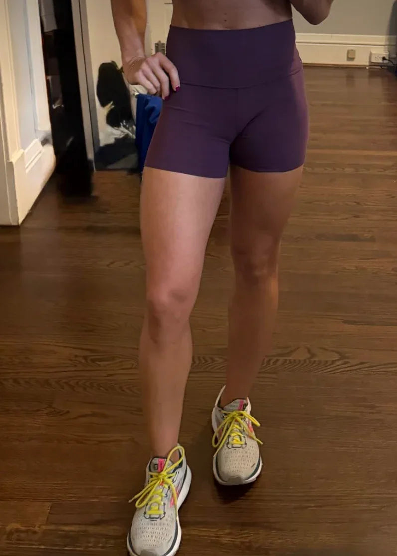 Person wearing purple shorts with a product review on Amazon displayed above.