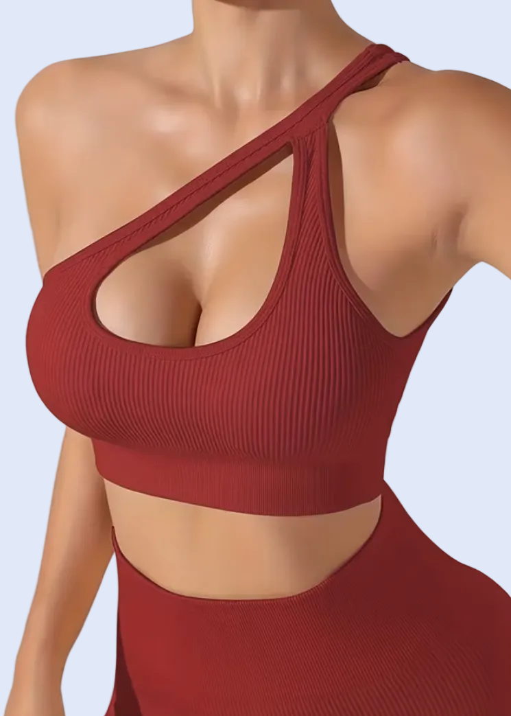 Red sports bra and leggings on a model against a white background