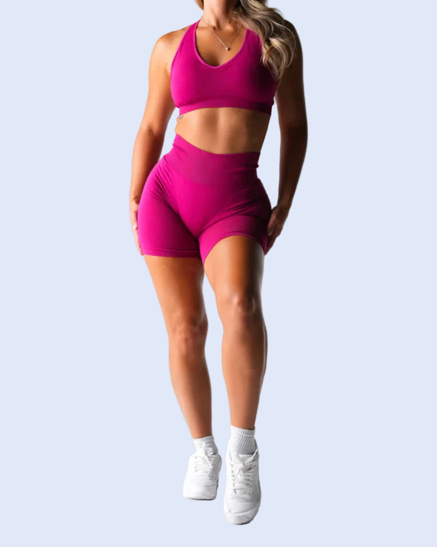 Person wearing a pink athletic outfit on a white background