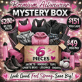 Promotional image of a premium activewear mystery box with fitness products on a wooden surface.