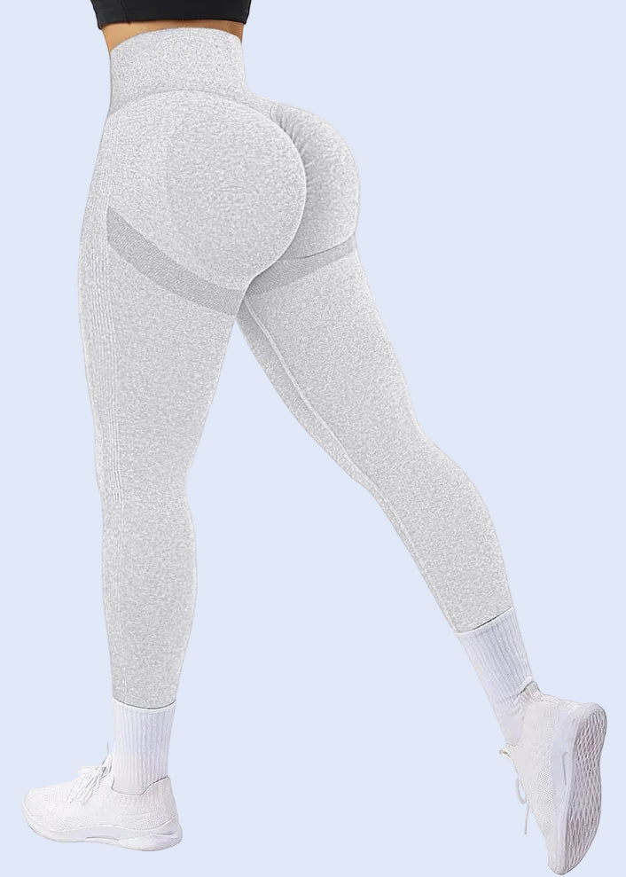 Gray leggings worn by a person on a white background