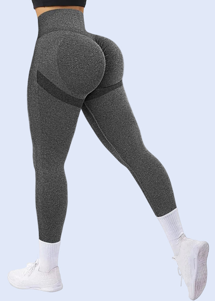 Gray leggings worn by a person on a white background