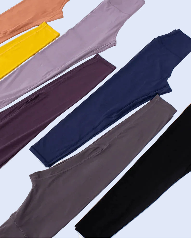 Set of colorful leggings in various shades on a white background