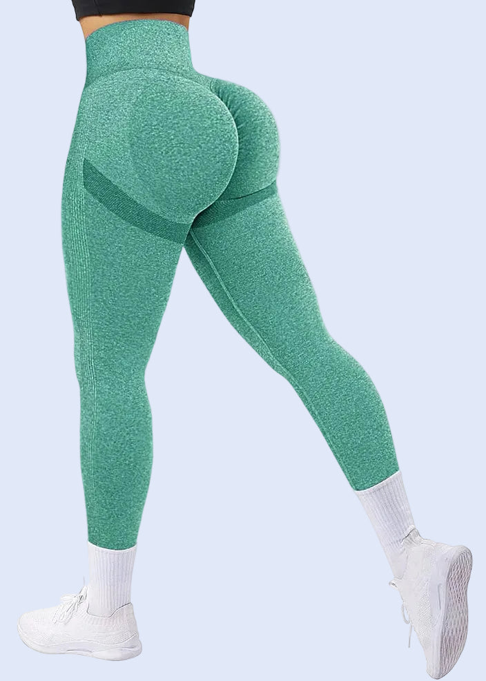 Green leggings worn by a person on a white background