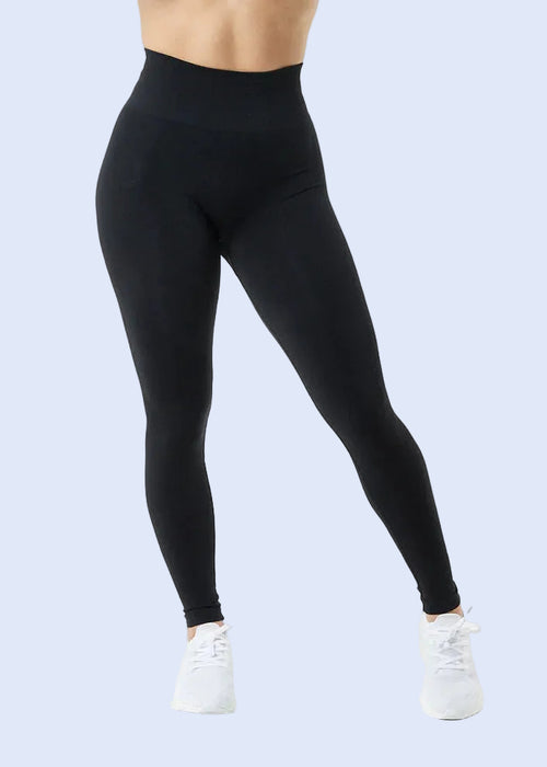 Person wearing black leggings on a white background