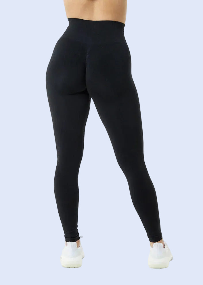 Black leggings worn by a person on a white background