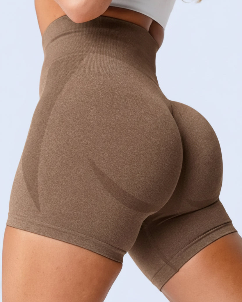 Brown shorts worn by a person on a white background
