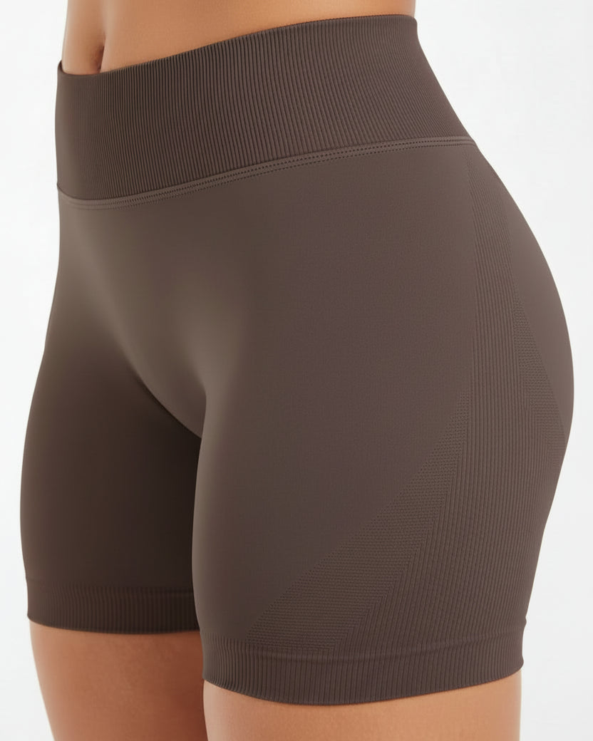 Brown athletic shorts worn by a person on a white background