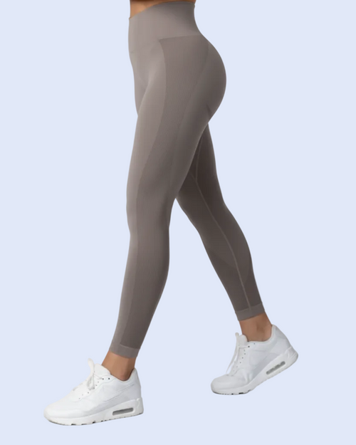 Hero side pose in the taupe-gray activewear set