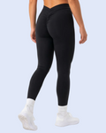 Three-quarter back walking-away pose in black leggings